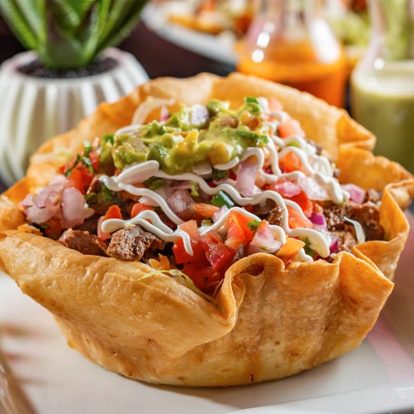 Mezcal Express Dearborn's taco salad in a crispy tortilla bowl with meat, pico de gallo, and guacamole.